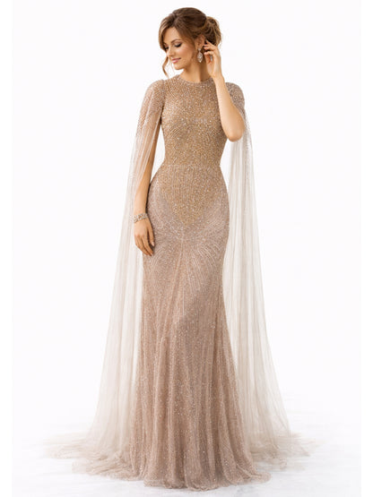 Woman wearing a sparkly gold evening gown with a sheer cape on a white background